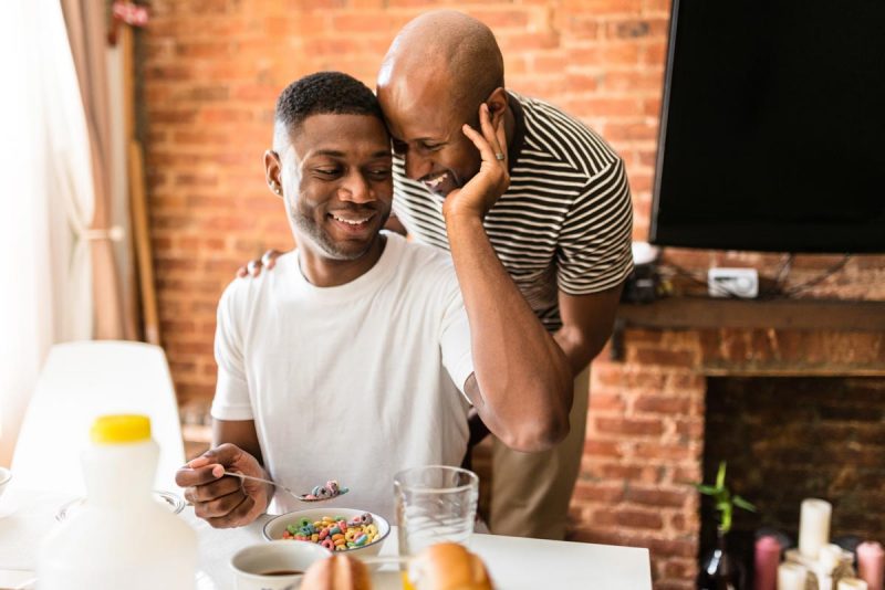 homosexual couple doing breakfast on the kitchen togetherness