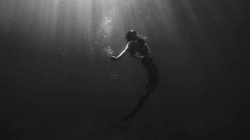 woman underwater like depth psychotherapy