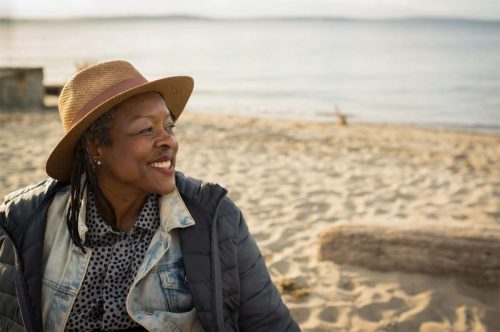 A woman finds happiness on the beach in San Francisco